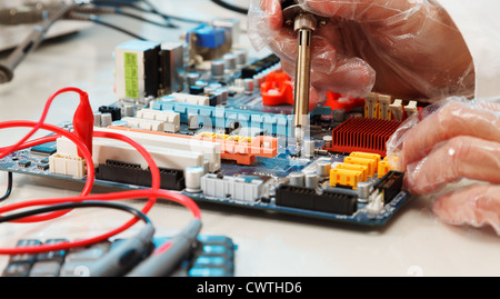 Replacement of electronic components on printed circuit board Stock Photo