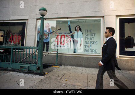 Shoppers pass a window display at a Gap clothing store in the Chelsea neighborhood of New York Stock Photo