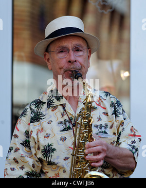 Saxophonist playing in a Jazz band busking on the streets of Paris, France Stock Photo