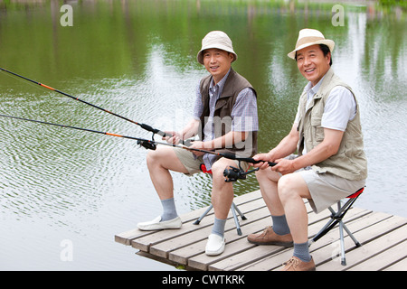 Senior friends fishing together Stock Photo