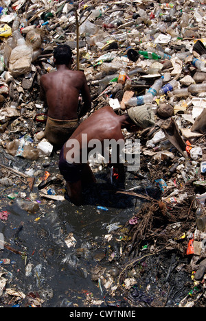 Workers Removing Plastic Waste from Contaminated Sewage filled infectious river flowing through Trivandrum city of Kerala India Stock Photo