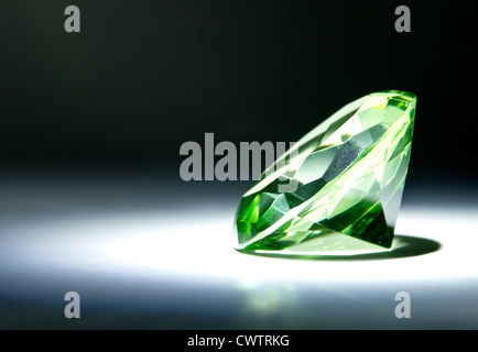 Faceted round cut green gemstone painted with light Stock Photo