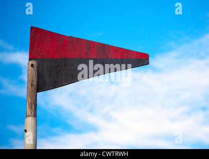 Wooden triangle red-black flag on a playground Stock Photo