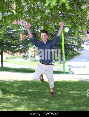 happy and jumping young man in park Stock Photo