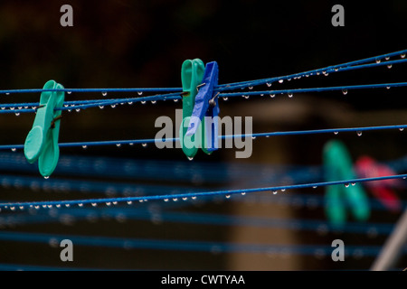 clothes pegs on washing line in the rain Stock Photo