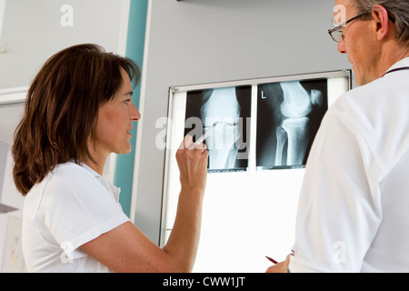 Doctor and nurse examining x-rays Stock Photo
