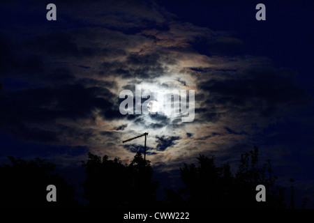 Beautiful, bright moon shining through the clouds Stock Photo