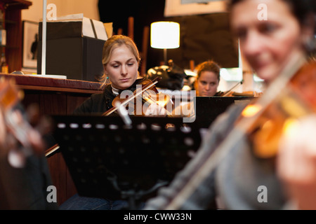 Violin player practicing with group Stock Photo