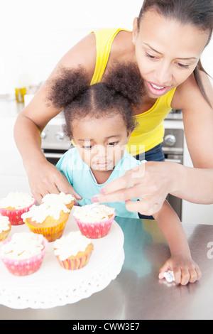 Mother and daughter baking together Stock Photo