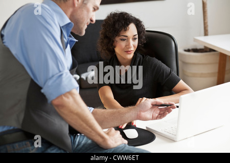 Business people working together at desk Stock Photo