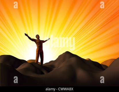 Worship and faith symbol represented by a man on a mountain top with his arms open on a glowing sunset background showing the concept of God and spirituality. Stock Photo