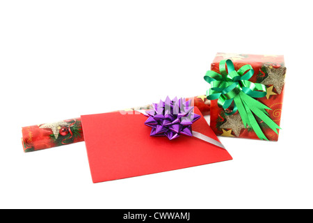 Gift box and roll paper with gift card on white background Stock Photo