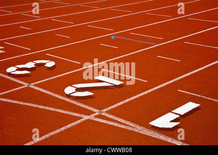Track and field surface with numbers and orange color Stock Photo - Alamy