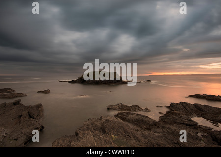 Blurred view of water washing on rocks Stock Photo