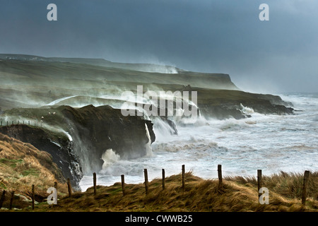 Waves crashing on rocky cliffs Stock Photo