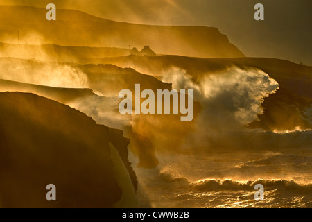 Waves crashing on rocky cliffs Stock Photo