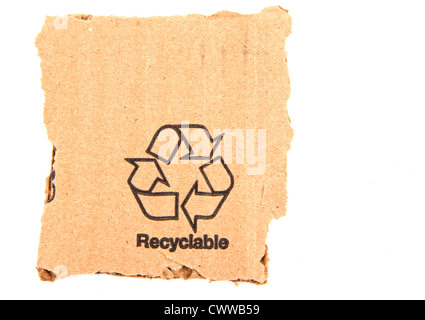 A recycle symbol printed on a ripped piece of cardboard. Stock Photo