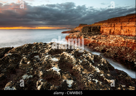 Waves washing up on rock formations Stock Photo