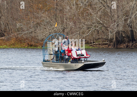 Man taking family on an airboat ride on Withlacoochee River near Inverness in Central Florida Stock Photo