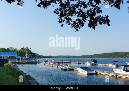 Boats on the Kennebec River in the late afternoon with the Kenebec Tavern in the distance, Bath, Maine, USA Stock Photo