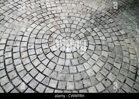Closeup view on a cobblestone road - circle pattern - background Stock Photo
