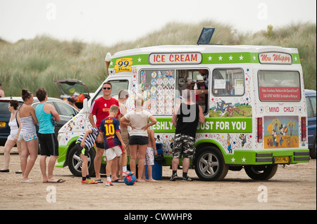 People queuing for ice creams from a van on a August afternoon, Ynys las beach, Dyfi estuary, West wales UK Stock Photo