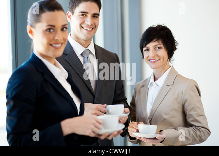 group of businesspeople having coffee during break in office Stock Photo