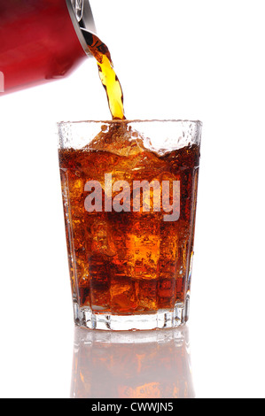 Cola pouring from a can into a glass filled with Ice. Vertical format isolated over a white background.