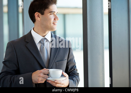 young businessman having coffee break at work Stock Photo