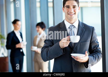 young businessman having coffee break in office Stock Photo