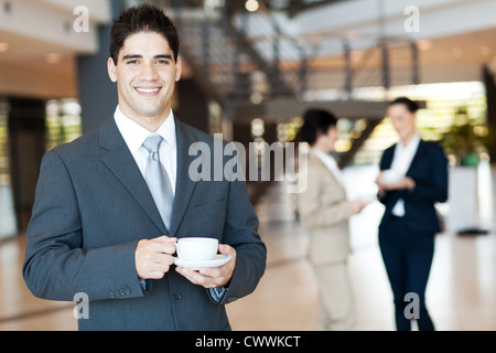 handsome businessman having coffee break in office Stock Photo