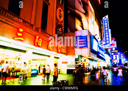 Shanghai, China - August 19, 2009: Thousands of foreign and local tourists stroll nightly under bright neon signs along Nanjing Stock Photo