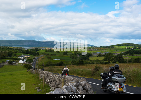 Motorbikes on winding country road in the Burren' region of County Clare, Republic of Ireland. Stock Photo