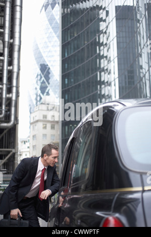Businessman talking to taxi driver Stock Photo