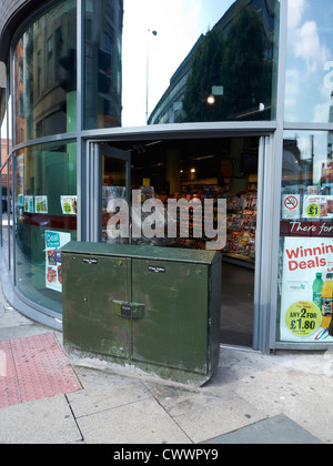 Telephone junction box blocking entrance to shop in Manchester UK Stock Photo