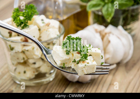 Fork with Feta Cheese on wooden background Stock Photo