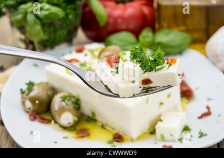 Fork with Feta and portion in the background Stock Photo