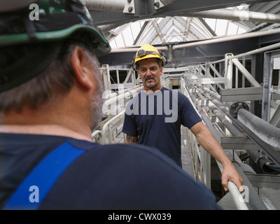 Workers talking in factory Stock Photo