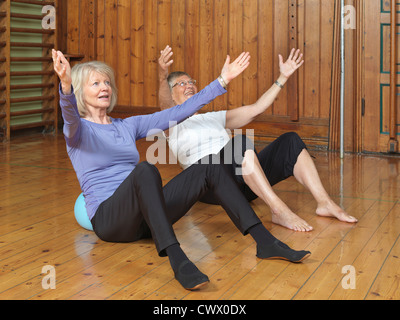 Women practicing yoga together in studio Stock Photo