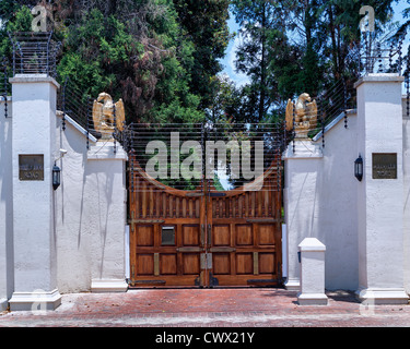 High walls and electric fences surround luxury homes Johannesburg Stock Photo