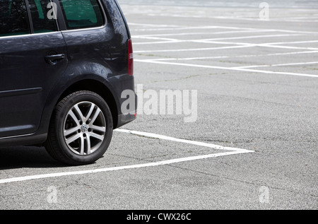 A single car parked on a large parking lot, concept image, parking spaces in Germany, Europe Stock Photo