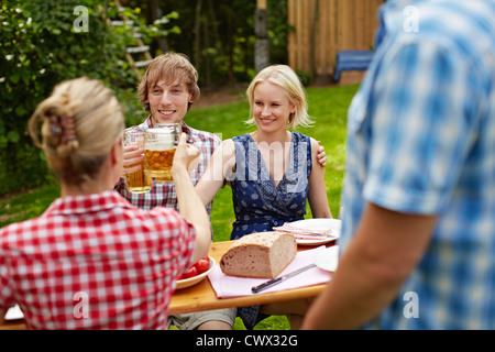Friends toasting each other outdoors Stock Photo