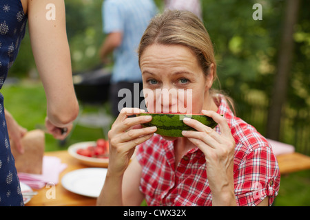 Woman eating watermelon outdoors Stock Photo