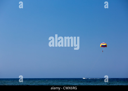 Tourists are towed behind a motor boat in Agios Georgios, Corfu, Ionian Islands, Greece. Stock Photo