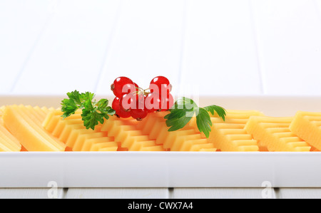 Hard cheese cut into triangles Stock Photo