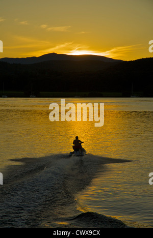 Man riding jet-ski on Lake Windermere, Lake District National Park, Cumbria, England UK Stock Photo