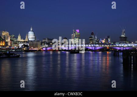 City of London and St Paul's Cathedral floodlit at night, with the River Thames and Blackfriars Bridge Stock Photo