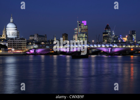 City of London UK at dusk, with the River Thames, St Paul's Cathedral and Blackfriars Bridge, illuminated Stock Photo