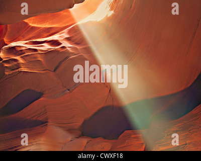 Diagonal sun beam in red rock slot canyon Stock Photo