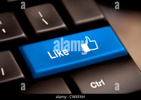 Blue thumb up like button on the keyboard. Stock Photo